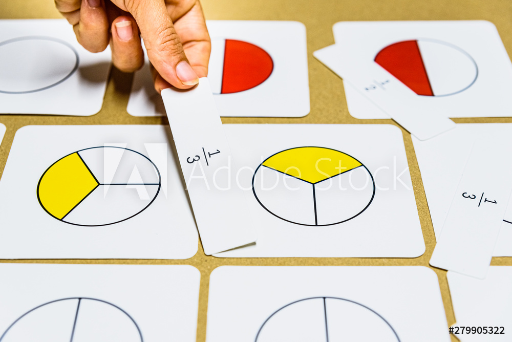 Hand of teacher montessori guide graphically shows fractions with mathematical cards.